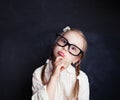 ÃÂ¡urious child thinking. Funny little girl in glasses Royalty Free Stock Photo